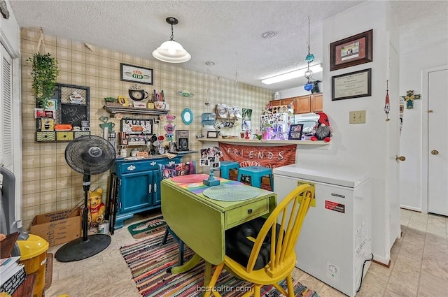 recreation room with a textured ceiling