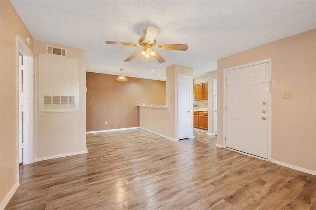 empty room featuring ceiling fan and light hardwood / wood-style flooring