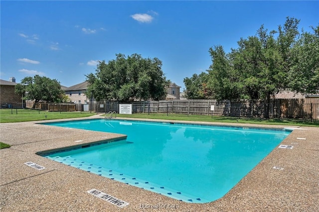 view of swimming pool with a patio area and a lawn