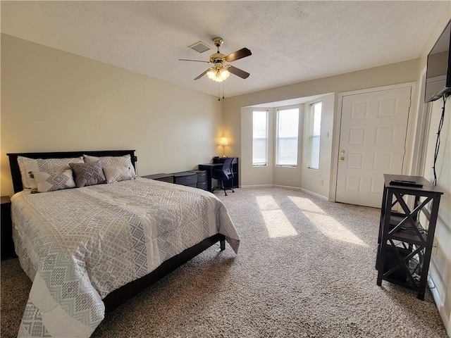 bedroom with a textured ceiling, ceiling fan, and carpet