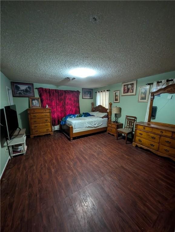 812 Victoria St, Navasota, TX 77868 - bedroom featuring wood finished floors and a textured ceiling