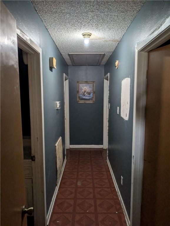 812 Victoria St, Navasota, TX 77868 - hall featuring a textured ceiling and attic access
