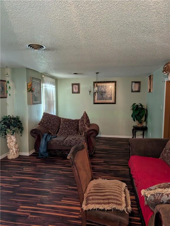 812 Victoria St, Navasota, TX 77868 - living area featuring a textured ceiling and wood finished floors