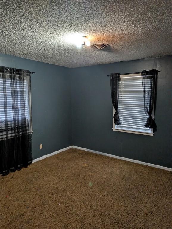 812 Victoria St, Navasota, TX 77868 - carpeted empty room featuring a textured ceiling