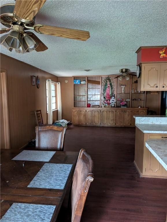 812 Victoria St, Navasota, TX 77868 - dining area featuring a textured ceiling, ceiling fan, dark wood finished floors, and wooden walls