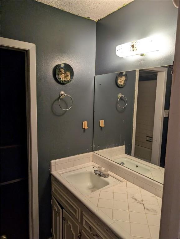 812 Victoria St, Navasota, TX 77868 - bathroom featuring vanity and a textured ceiling
