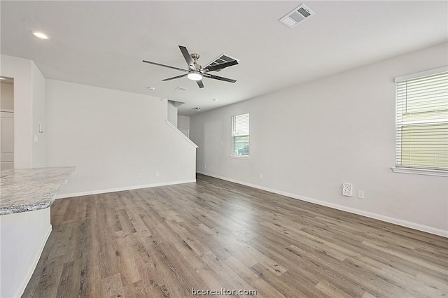 unfurnished living room with ceiling fan and hardwood / wood-style floors