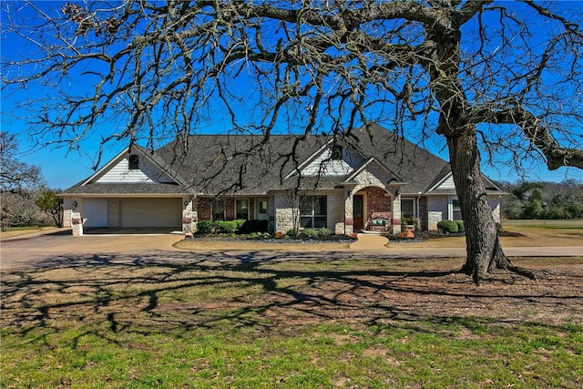 view of front of house with an attached garage and brick siding