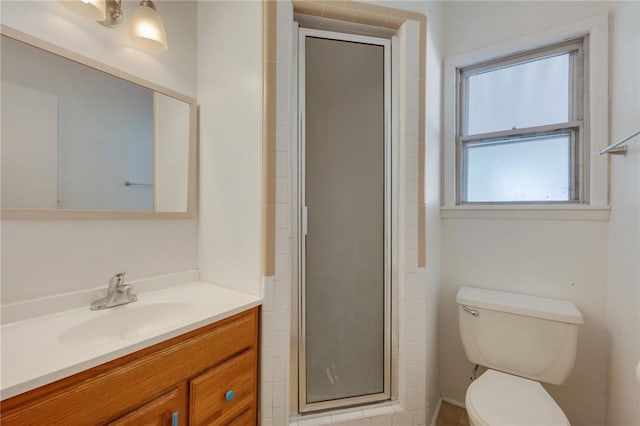 full bath with a shower stall, toilet, and vanity