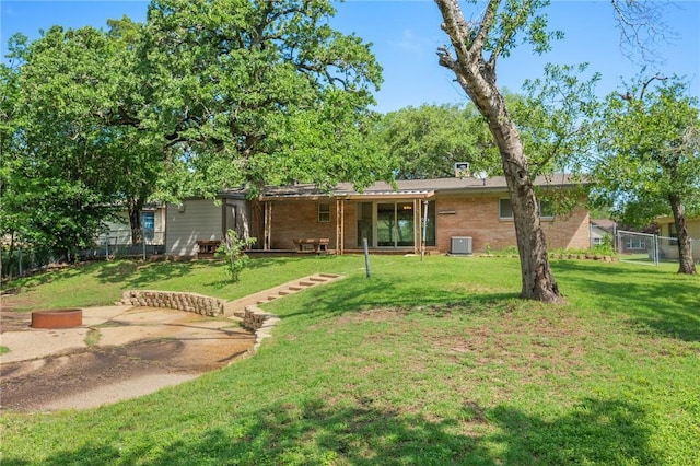 back of house with central AC unit and brick siding