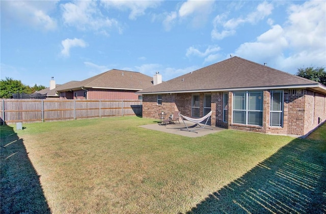 back of property featuring a patio area and a yard