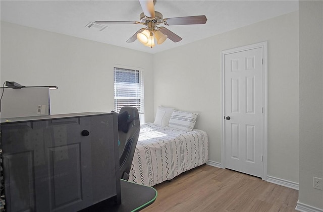 bedroom with light wood-type flooring and ceiling fan