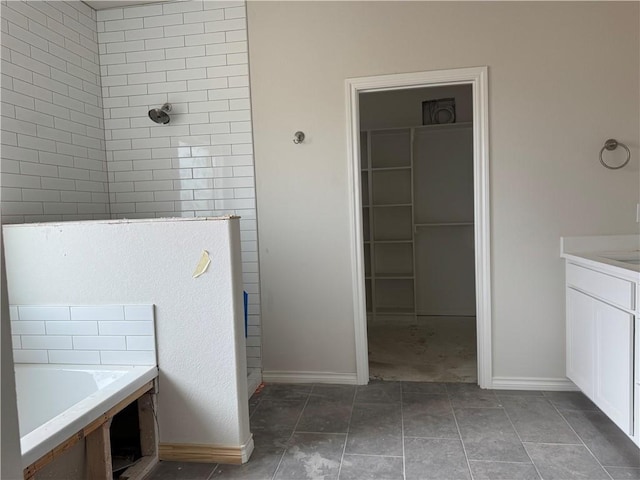 bathroom with vanity, a garden tub, tile patterned flooring, and a tile shower