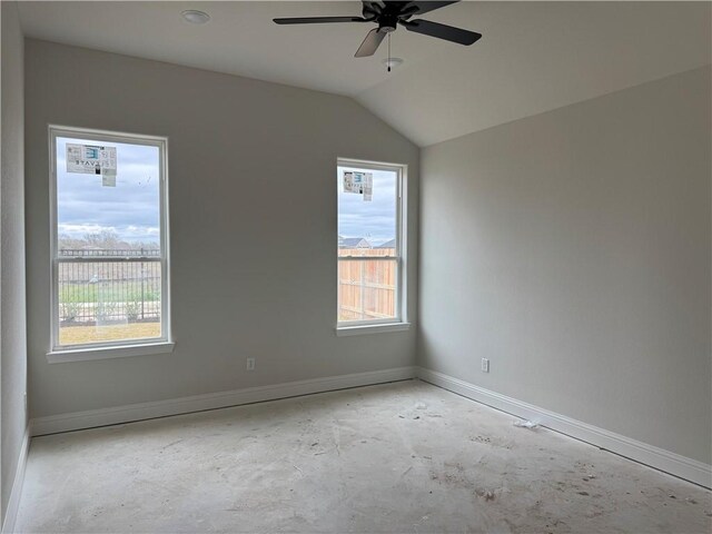 unfurnished room with baseboards, lofted ceiling, and a ceiling fan