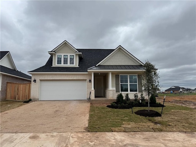 craftsman inspired home with brick siding, fence, concrete driveway, a garage, and a standing seam roof