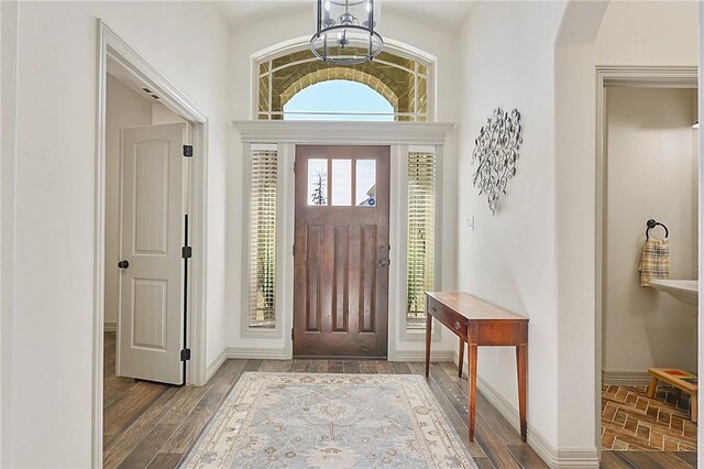 4111 Downton Abbey Ave, College Station, TX 77845 - foyer entrance with baseboards, wood finished floors, and a chandelier