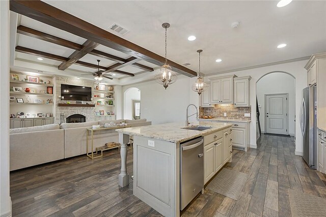 4111 Downton Abbey Ave, College Station, TX 77845 - kitchen with a kitchen island with sink, ceiling fan, arched walkways, a sink, and appliances with stainless steel finishes