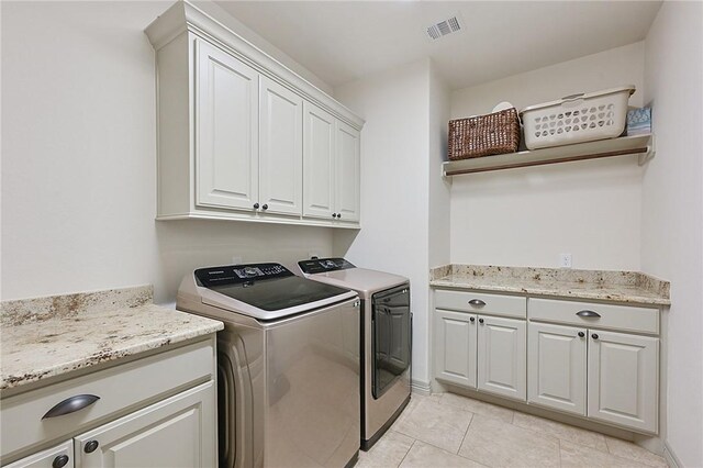 4111 Downton Abbey Ave, College Station, TX 77845 - laundry area with visible vents, washing machine and dryer, cabinet space, and light tile patterned flooring