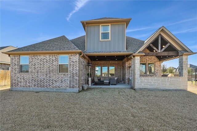 4111 Downton Abbey Ave, College Station, TX 77845 - back of property featuring board and batten siding, a patio area, brick siding, fence, and an outdoor hangout area
