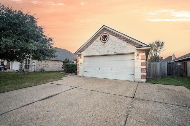 garage at dusk with a lawn