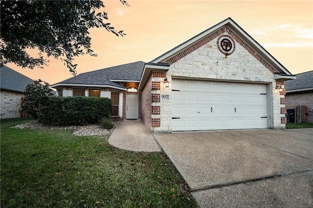 ranch-style house featuring a lawn and a garage