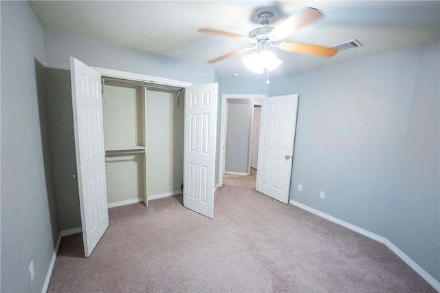 unfurnished bedroom with ceiling fan, a closet, and light colored carpet