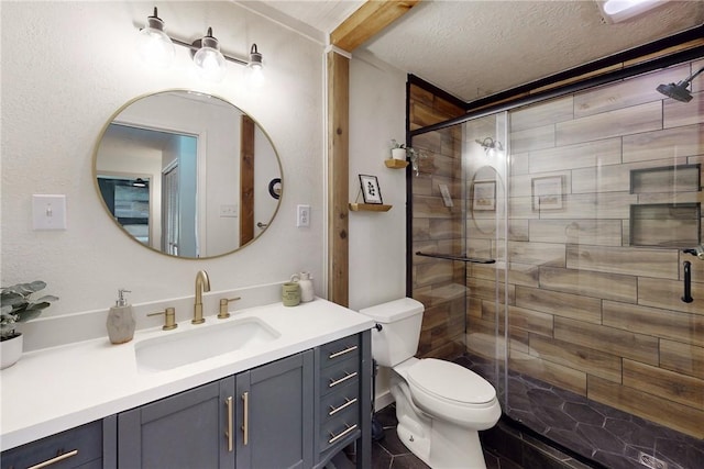 bathroom featuring a shower with door, vanity, a textured ceiling, and toilet