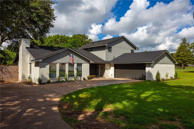 view of front facade with a garage and a front lawn