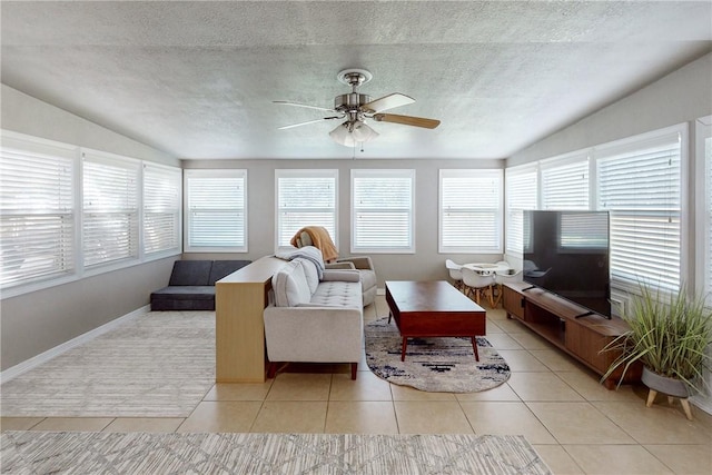 tiled living room featuring a textured ceiling, ceiling fan, and lofted ceiling