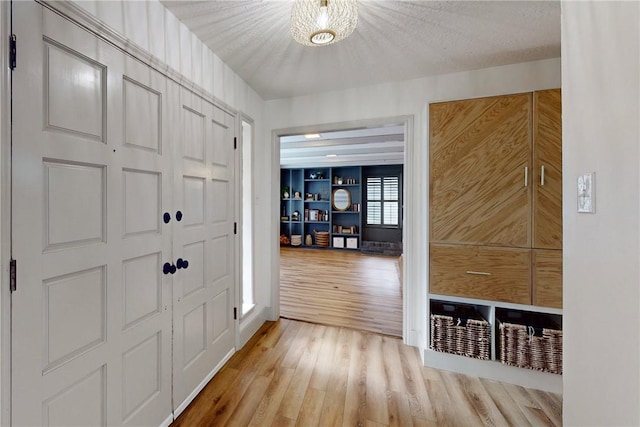 entrance foyer featuring a textured ceiling and light wood-type flooring