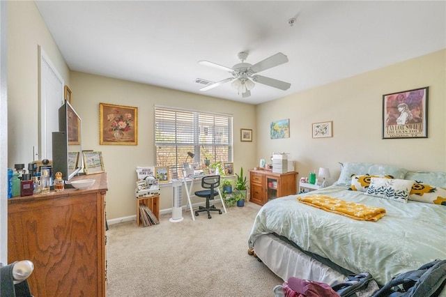 bedroom featuring visible vents, a ceiling fan, baseboards, and light carpet