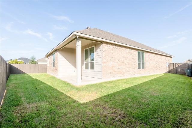 rear view of house featuring a yard