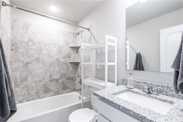 full bathroom with vanity, toilet, and tiled shower / bath combo