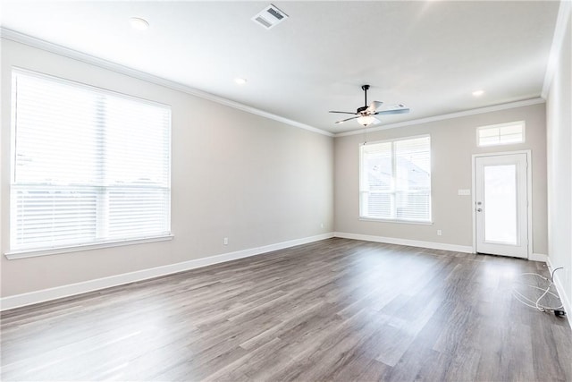 unfurnished room featuring ceiling fan, wood-type flooring, and ornamental molding