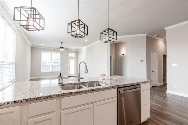 kitchen with white cabinets, light stone counters, stainless steel dishwasher, and sink