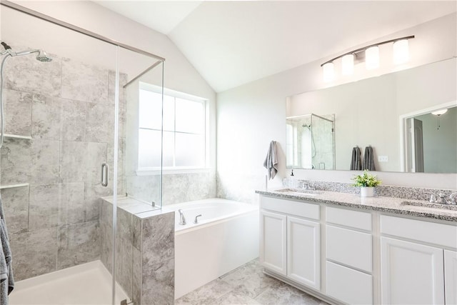 bathroom featuring vanity, separate shower and tub, and lofted ceiling