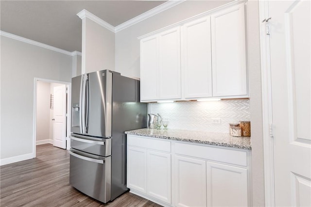 kitchen featuring white cabinetry, light stone countertops, stainless steel fridge with ice dispenser, and crown molding