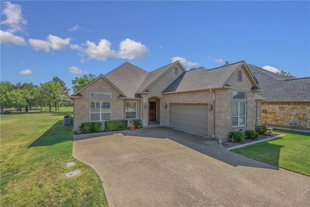 view of front of house with a front yard and a garage