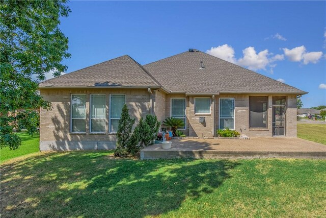 back of property featuring a lawn and a patio area