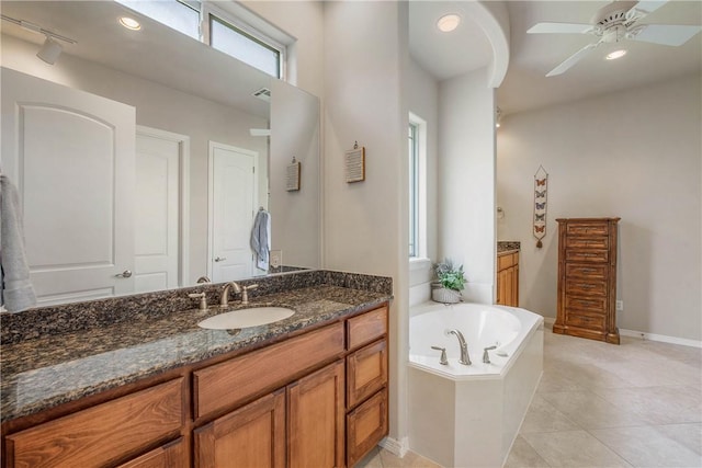 bathroom with tile patterned flooring, vanity, ceiling fan, and a bath