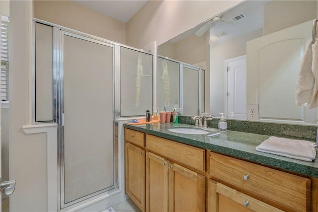 bathroom featuring vanity, ceiling fan, and walk in shower