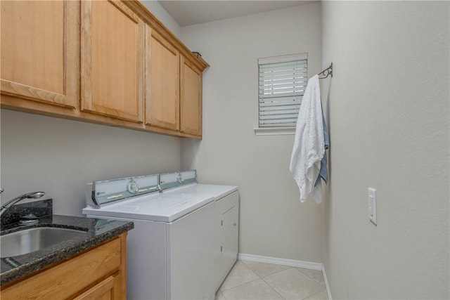 laundry room featuring washer and dryer, light tile patterned flooring, cabinets, and sink