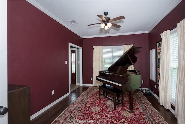 misc room with crown molding, dark hardwood / wood-style flooring, and ceiling fan