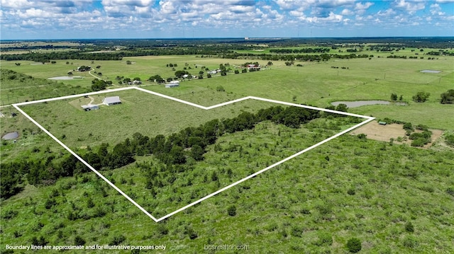 birds eye view of property with a rural view