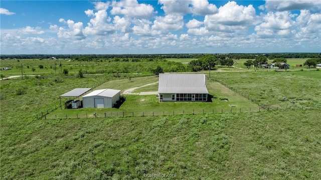 birds eye view of property with a rural view