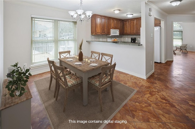 dining room featuring crown molding, dark tile patterned flooring, and a chandelier