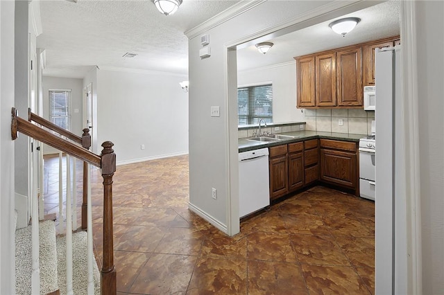 kitchen featuring a healthy amount of sunlight, ornamental molding, sink, and white appliances