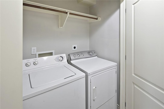 clothes washing area featuring separate washer and dryer