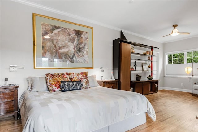 bedroom with a ceiling fan, wood finished floors, baseboards, and ornamental molding