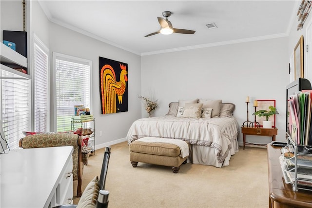 bedroom featuring a ceiling fan, crown molding, visible vents, baseboards, and light carpet